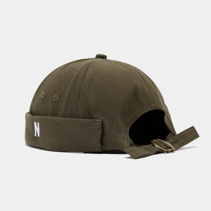 Detail of adjustable metal buckle and N embroidery on army green docker hat