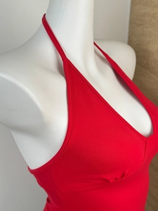 Detail of red halter neck top showing the fine plain weave texture on a white mannequin