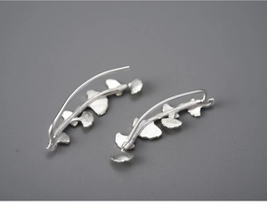 Macro view of S925 sterling silver ginkgo leaf earrings showing the hallmark detail