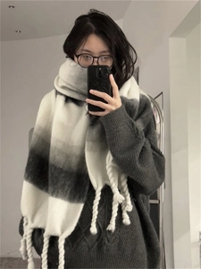 Detailed texture of gradient black and white mohair scarf with fringe trim