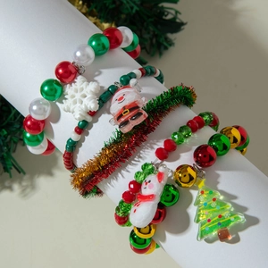 Christmas beaded bracelet set with Santa Claus and tree charms on a festive white display