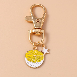 Detailed close-up of a lemon slice keychain with gold lobster clasp and star charm