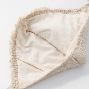 Cozy baby knitted hat in beige with lace trim and soft skin-friendly cotton lining