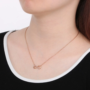 Elegant rose gold infinity necklace with micro-pave zircons worn by a model