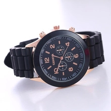 Detailed macro view of Geneva watch featuring black silicone strap and rose gold case