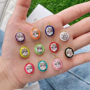 Set of 10 colorful enamel oval pendants with gold edges and cubic zirconia stones