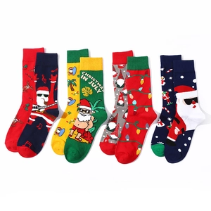 Pack of four cotton Christmas socks with Santa and reindeer patterns on white background