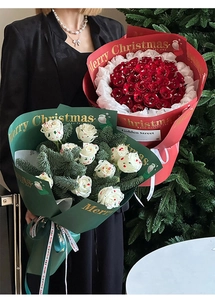 Detail of Christmas gift bouquet wrapping paper with gold foil snowflake and rose design