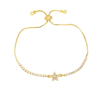 Macro detail of gold star bracelet featuring pavé zircon star and adjustable slider clasp