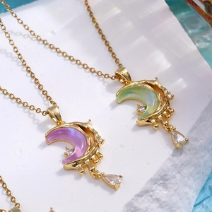 Gold moon pendant necklace with purple and green zircon crystals and tiny rhinestones
