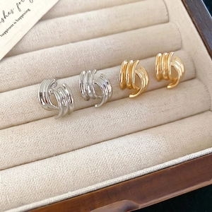 Minimalist geometric curved silver needle earrings in gold and silver metal finishes