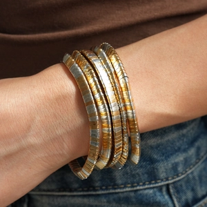 Detail of mixed-metal Tubogas wrap bracelet showing gold and silver interlocking layers