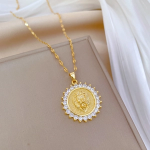 Golden lion head pendant necklace with sparkling crystal halo on elegant silk background