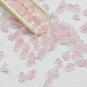 Macro shot of 7x12mm pink lily of the valley glass beads for DIY jewelry making