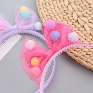Girl's princess hairband with large mesh bow and colorful pompons in pink and purple
