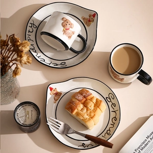 Detailed top view of ceramic coffee cup and saucer set with 3D brown bear motifs
