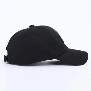 Close-up of black baseball cap side view with metal buckle and detailed fabric texture