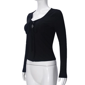Detail of the black long sleeve lace-up V-neck top showing soft knit fabric and tie design