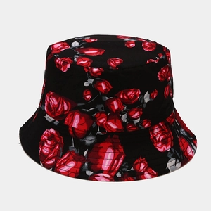 Close-up of vibrant red rose floral print on a black cotton bucket hat fabric