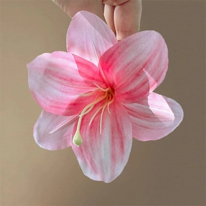 Detail of pink and white striped lily hair clip with realistic silk petals and white stamen