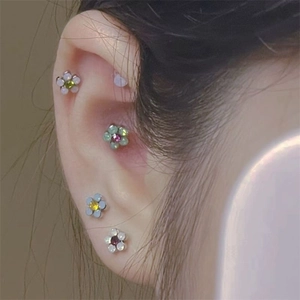 Colorful floral titanium steel stud earrings set with zircon stones on the ear