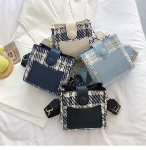 Detail of tweed and leather crossbody bags with patterned wide straps in multiple colors