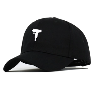 Black cotton baseball cap with white machine gun embroidery in a classic six-panel design