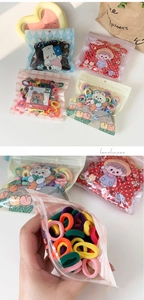Detail of colorful elastic hair ties for kids in transparent packaging bags
