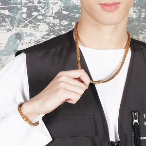 Men's gold stainless steel keel chain necklace and bracelet set shown on a male model