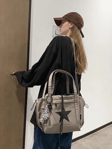 Water-resistant gray nylon tote with black star print and checkered charm for couples
