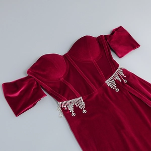 Detailed view of corset bodice with rhinestones on a burgundy velvet dress