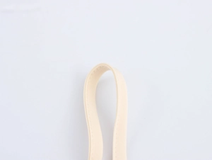 Detailed macro view of the cream fabric shoulder strap showing neat stitching and fine weave