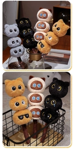 Macro shot of fluffy cat plush sticks in gray black beige and orange with cute facial expressions