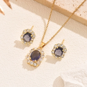 Elegant gold necklace and earring set featuring deep purple oval zircon stones and crystals