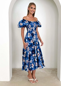 Close-up of a floral puff sleeve dress with a deep blue base and layered skirt details