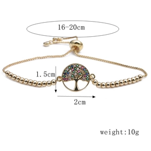 Macro shot of gold tree of life bracelet charm with colorful cubic zirconia stones