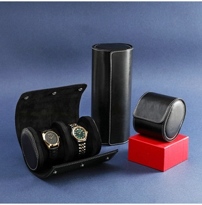 Detail view of black leather watch cases with white stitching and soft velvet lining