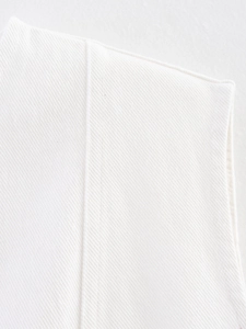 Macro detail of high-quality white twill denim fabric with clean stitching and premium texture