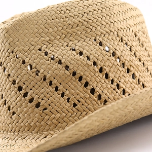 Detailed close-up of hollow diamond weave pattern on natural straw cowboy hat