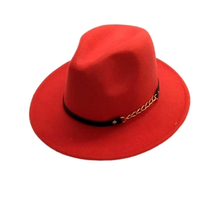 Detail of red fedora hat with black leather band and decorative gold chain accent