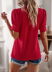 Detail showing red puff sleeve t-shirt with hollow embroidery and textured fabric