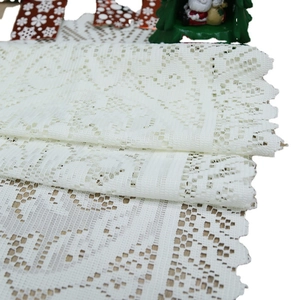 White Christmas lace table runner with intricate floral embroidery and scalloped edges