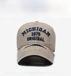 Detail of vintage khaki baseball cap with blue Michigan 1975 embroidery and distressed brim