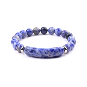 Macro shot of blue spotted stone beaded bracelet with curved bar and metal spacers