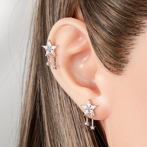 Star-shaped silver tassel earrings with zircon studs and blue accents on a female model