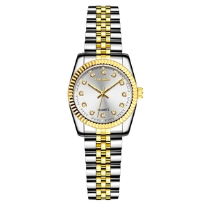 Detail of two-tone gold and silver watch with rhinestone indices and fluted bezel