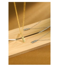 Detailed close-up of S925 silver star zircon pendants on wooden background
