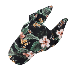 Detailed pattern showing hibiscus flowers and monstera leaves on black fabric headwrap