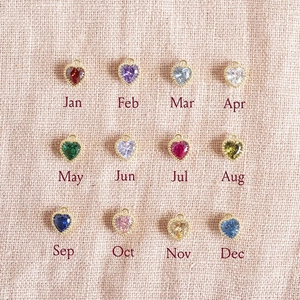 Golden heart-shaped birthstone pendant earrings collection featuring 12 vibrant colors
