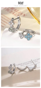 Macro view of French retro silver hoop earrings featuring micro-set zircon floral charms